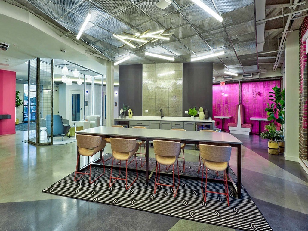an open office space with a large table and chairs